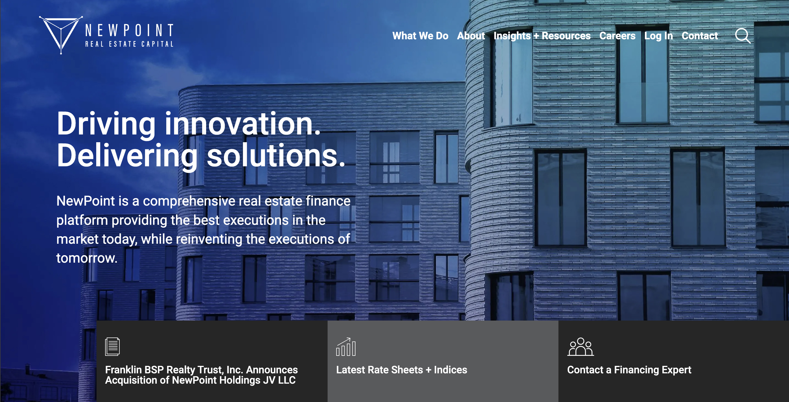 Photograph of a corporate building with "Driving Innovation, Delivering Solutions" heading.